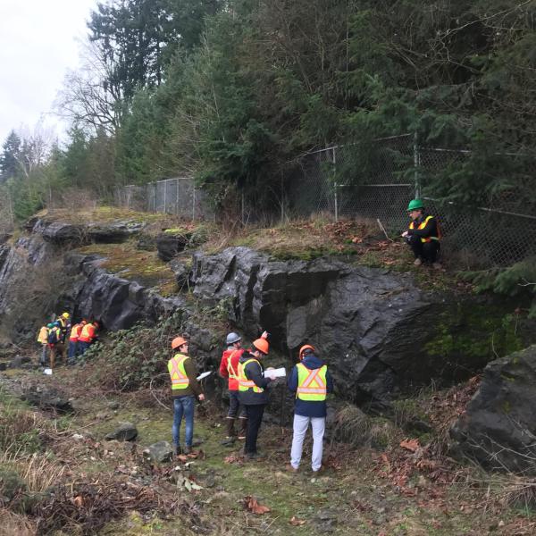 Students learning to take structural measurements and make geological observations at Malaspina Cut